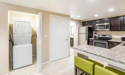a kitchen with a white refrigerator freezer next to a counter at Vacation Village Orlando, Celebration in Orlando