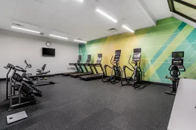 a gym with several treadmills and exercise bikes at Holiday Inn Orlando International Dr-ICON by IHG in Orlando