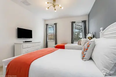 a bedroom with two beds and a flat screen tv at Veranda Palms 8 Bedroom Home with Pool 1722 in Kissimmee
