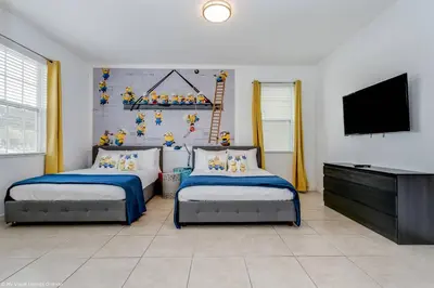 a bedroom with two beds and a flat screen tv at Veranda Palms 8 Bedroom Home with Pool 1722 in Kissimmee