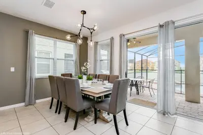 a dining room with a table and chairs at Veranda Palms 8 Bedroom Home with Pool 1722 in Kissimmee