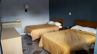 a hotel room with two beds in a room at Budget Motel in Orlando