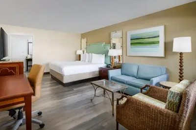 a hotel room with a bed and a living room at Coco Key Hotel & Water Park Resort in Orlando