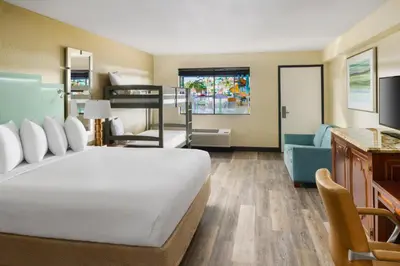 a bedroom with a bed and a living room at Coco Key Hotel & Water Park Resort in Orlando