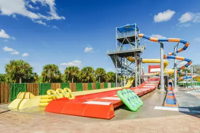 a water slide at a water park with a roller coaster at Coco Key Hotel & Water Park Resort in Orlando