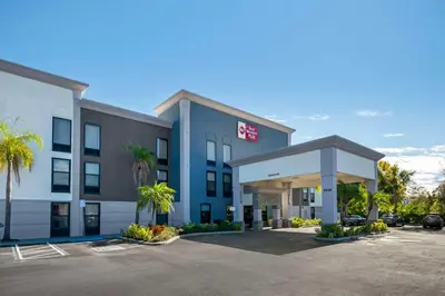 a hotel with a parking lot in front of it at Best Western Plus Universal Inn - Free Shuttle to Universal Studios! in Orlando
