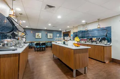 a large kitchen with wooden counter tops and blue walls at Best Western Plus Universal Inn - Free Shuttle to Universal Studios! in Orlando
