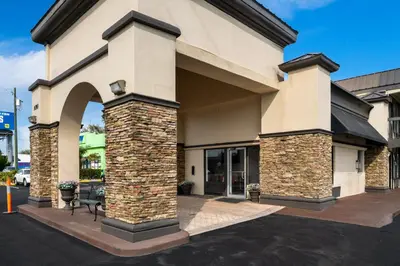 a building with an arch in a parking lot at Americas Best Value Inn Orlando, FL in Orlando