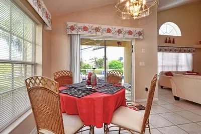 a dining room with a table with a red table cloth at Mickey's Lake Villa in Orlando