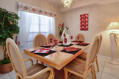 a dining room with a wooden table and chairs at Mickey's Lake Villa in Orlando