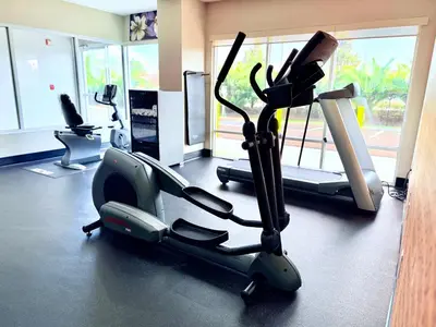 a gym with exercise bikes and a treadmill at La Quinta by Wyndham Orlando Universal area - Free Shuttle to Universal in Orlando