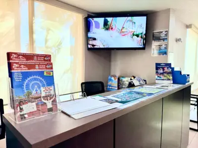 a desk with a tv on a wall at La Quinta by Wyndham Orlando Universal area - Free Shuttle to Universal in Orlando