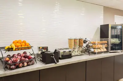 a counter with fruits and other foods on it at La Quinta by Wyndham Orlando Universal area - Free Shuttle to Universal in Orlando