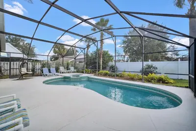 a swimming pool with a pergola and a patio at Indian Creek 3.5 miles from Disney in Orlando