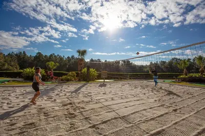 two people playing a game of volley ball on a court at Westgate Leisure Resort in Orlando