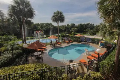 a pool at a resort with a waterfall and palm trees at Westgate Leisure Resort in Orlando