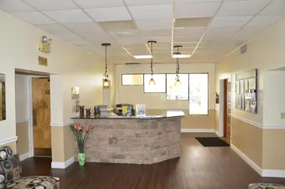 a lobby with a bar in the middle of a building at Orlando RV Resort in Orlando
