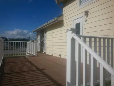a porch of a house with a white fence at Orlando RV Resort in Orlando