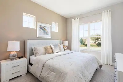 a bedroom with a white bed and a window at Summerville Vacation Resort in Orlando