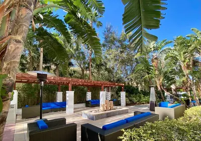 a patio with blue chairs and a fire pit at The Westin Lake Mary, Orlando North in Lake Mary