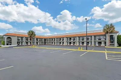 an empty parking lot in front of a building at Quality Inn & Suites Orlando East - UCF Area in Orlando