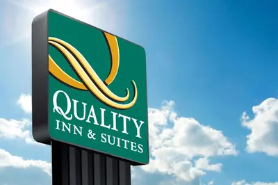 a sign for a quality inn and suites at Quality Inn & Suites Orlando East - UCF Area in Orlando