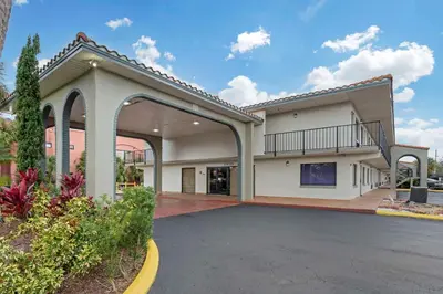 an empty parking lot in front of a building at Quality Inn & Suites Orlando East - UCF Area in Orlando