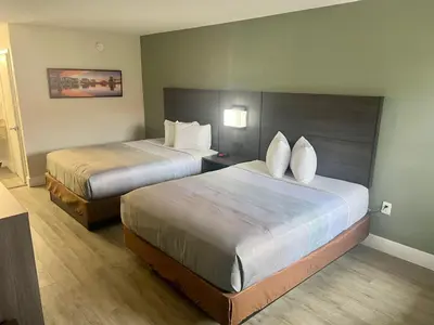 a hotel room with two beds in a room at Quality Inn & Suites Orlando East - UCF Area in Orlando