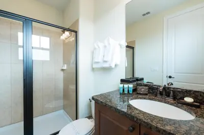 a bathroom with a sink and a shower and a toilet at Luxury Disney Dreams Home with Pool, Spa & Game Room in Orlando