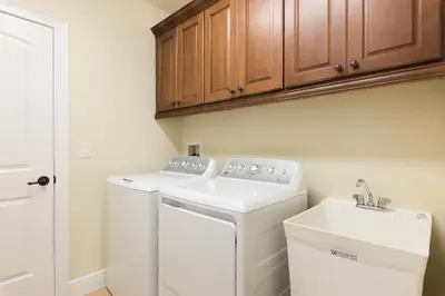 a laundry room with a washer and dryer at Luxury Disney Dreams Home with Pool, Spa & Game Room in Orlando