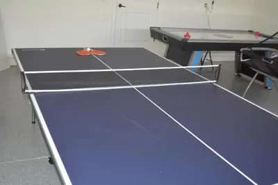 a ping pong table with a ping pong ball on it at Luxury Disney Dreams Home with Pool, Spa & Game Room in Orlando