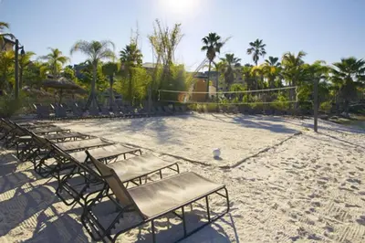 a group of lounge chairs on a sandy beach at Universal's Loews Royal Pacific Resort in Orlando