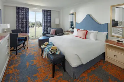a hotel room with a large bed and a desk at Universal's Loews Portofino Bay Hotel in Orlando