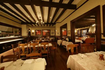 a restaurant with tables and chairs and a piano at Universal's Loews Portofino Bay Hotel in Orlando