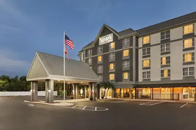 a hotel with an american flag in a parking lot at Spark by Hilton Orlando Universal Boulevard in Orlando