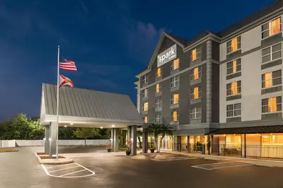 a hotel with an american flag in a parking lot at Spark by Hilton Orlando Universal Boulevard in Orlando