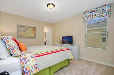a bedroom with a bed and a window and a television at Four Bedrooms Townhome 5126K in Kissimmee