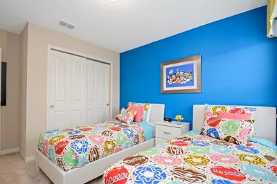 a bedroom with two beds and blue walls at Four Bedrooms Townhome 5126K in Kissimmee