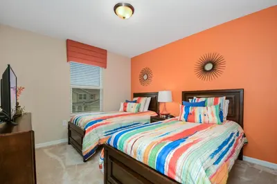 two beds in a bedroom with orange walls at Four Bedrooms Townhome 5126K in Kissimmee