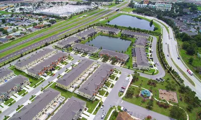 an aerial view of a city with a lake at Four Bedrooms Townhome 5126K in Kissimmee