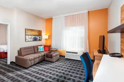 a living room with a couch and a tv at TownePlace Suites by Marriott Orlando Altamonte Springs/Maitland in Orlando
