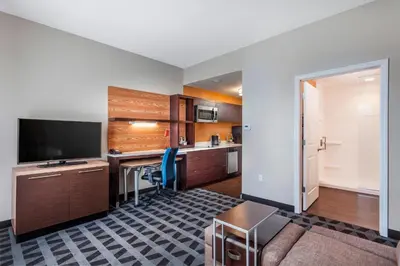 a room with a kitchen with a desk and a television at TownePlace Suites by Marriott Orlando Altamonte Springs/Maitland in Orlando