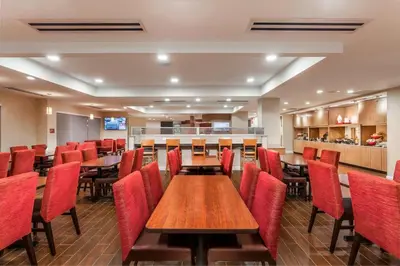 a dining room with tables and red chairs at TownePlace Suites by Marriott Orlando Altamonte Springs/Maitland in Orlando