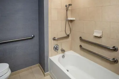 a bathroom with a toilet and a bath tub at Hyatt Place Lake Mary/Orlando North in Lake Mary