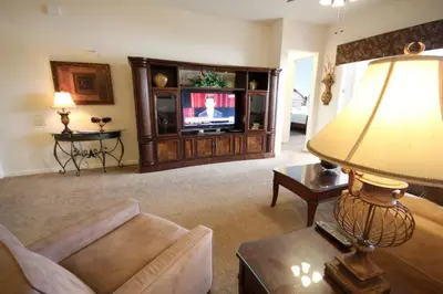 a living room with a couch and a television at Shoreway House #231533 in Orlando