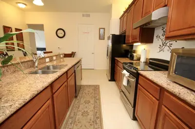 a large kitchen with a sink and a stove at Shoreway House #231533 in Orlando