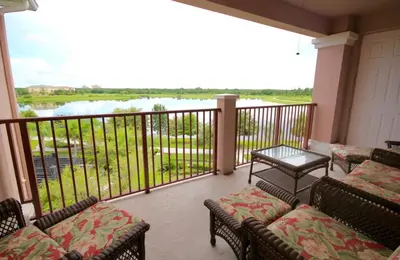 a balcony with chairs and a view of a river at Shoreway House #231533 in Orlando