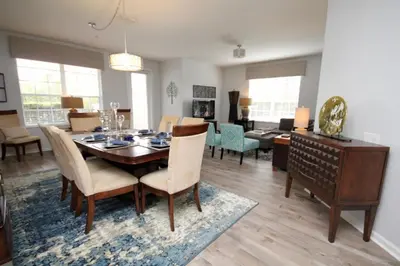 a dining room and living room with a table and chairs at Cayview Condo #231537 in Orlando