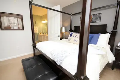 a bedroom with a canopy bed with a mirror at Cayview Condo #231537 in Orlando