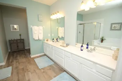 a bathroom with two sinks and a large mirror at Cayview Condo #231537 in Orlando
